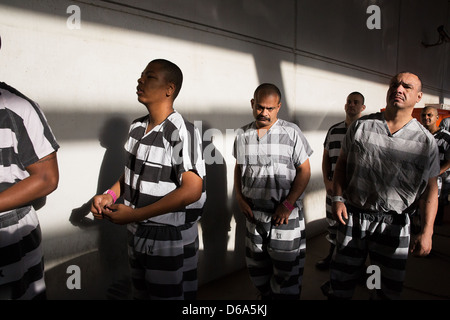 Male inmates wait in line to have their prison id photographs taken. Stock Photo