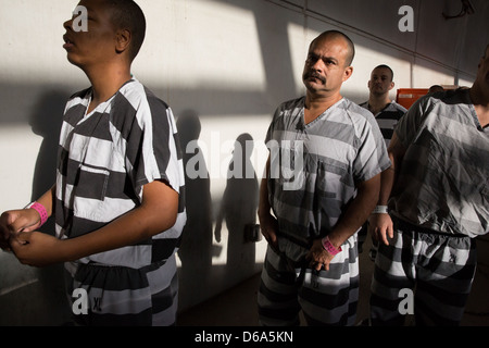 Male inmates wait in line to have their prison id photographs taken. Stock Photo