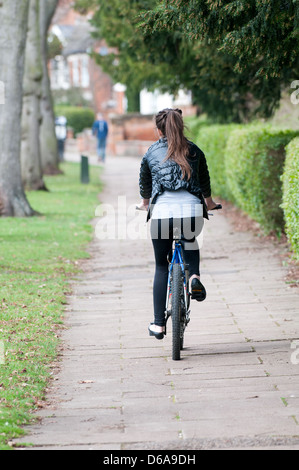 Woman cyclist on path Stock Photo