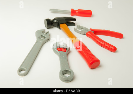 Set of plastic toy tools on a plain background. Stock Photo