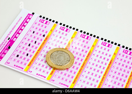 British lottery ticket with two pound coin Stock Photo