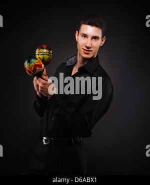 Handsome smiling man with maracas Stock Photo