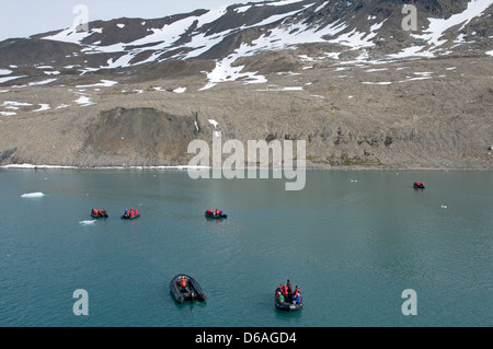 Norway, Svalbard Archipelago, Freemansund Channel. Zodiacs filled with tourists venture out amongst the sea ice Stock Photo