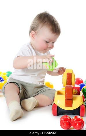 The little boy plays multi-coloured toys Stock Photo