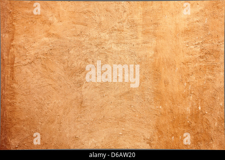 texture walls covered with brown plaster.close up. Wall traditional Arab houses covered with wild brown plaster applied by hand Stock Photo