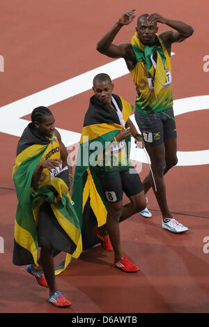 Usain Bolt (R-L), Warren Weir and Yohan Blake of Jamaica celebrate after the Men's 200m Final during the London 2012 Olympic Games Athletics, Track and Field events at the Olympic Stadium, London, Great Britain, 09 August 2012. Photo: Christian Charisius dpa  +++(c) dpa - Bildfunk+++ Stock Photo