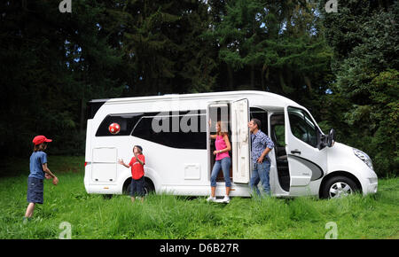 Models Niklas (L-R) and Julian Busse, Nicolette Baxmann and Ingo Busse stand in front of a Hobby motorhome on a Renault chassis in Duesseldorf, Germany, 15 August 2012. The trade fair 'Caravan Salon' takes place in Duesseldorf from 24 August till 02 September 2012. Photo: CAROLINE SEIDEL Stock Photo