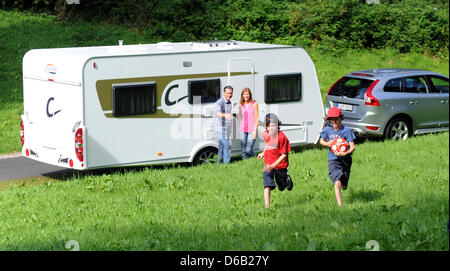 Models Niklas (R) and Julian Busse (2-R), Nicolette Baxmann (2-L) and Ingo Busse (L) stand in front of a Carado C366 caravan in Duesseldorf, Germany, 15 August 2012. The trade fair 'Caravan Salon' takes place in Duesseldorf from 24 August till 02 September 2012. Photo: CAROLINE SEIDEL Stock Photo