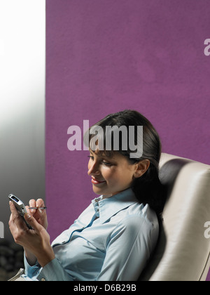 Businesswoman using cell phone Stock Photo