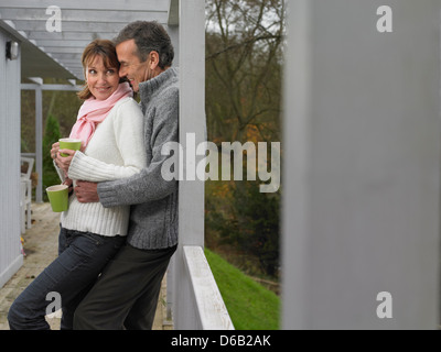 Couple having coffee together on patio Stock Photo