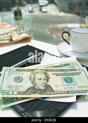 Money in check on restaurant table Stock Photo