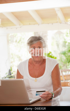Older woman shopping online Stock Photo
