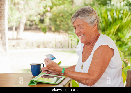 Older woman shopping online Stock Photo