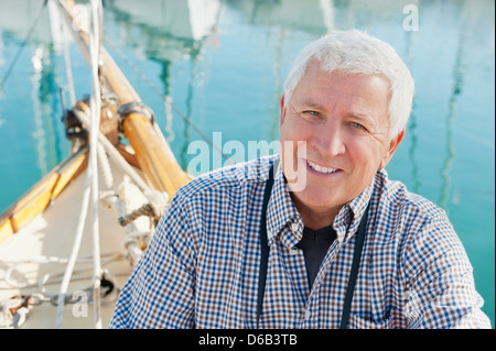 Older man sitting on boat Stock Photo