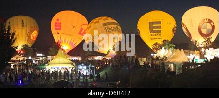 Hot air balloons glow shortly before the start of the fireworks festival 'Flaming stars' in Ostfildern, Germany, 17 Augsut 2012. Photo: Heiko Lossie Stock Photo