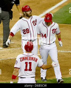 Washington right fielder Jayson Werth (28) congratulates center fielder Bryce Harper (34) after Harper's fifth inning two run home run against the New York Mets at Nationals Park in Washington, D.C. on Friday, August 17, 2012. Nationals third baseman Ryan Zimmerman (11) waits to congratulate Harper..Credit: Ron Sachs / CNP.(RESTRICTION: NO New York or New Jersey Newspapers or newsp Stock Photo