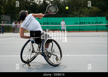 Wheelchair tennis pro Petra-Katharina Krueger plays fomer tennis pro Nicolas Kiefer at TennisBase in Hanover, Germany, 20 August 2012. 22-year-old Ms Krueger will compete in this year's Paralympics, which take place from 29 August to 9 September in London, Great Britain. Photo: EMILY WABITSCH Stock Photo