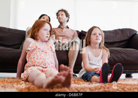 Family watching television together Stock Photo
