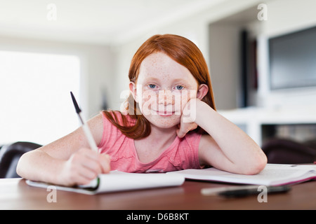 Smiling girl doing homework Stock Photo
