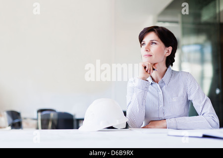 Businesswoman thinking at desk Stock Photo