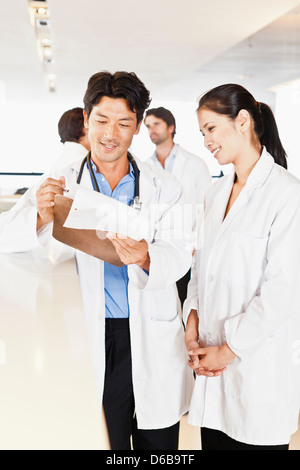 Doctor reading his notes to colleague Stock Photo