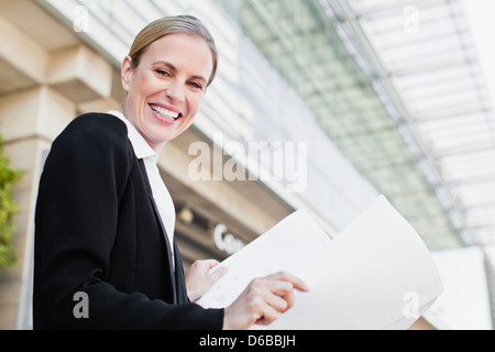 Businesswoman reading blueprints Stock Photo