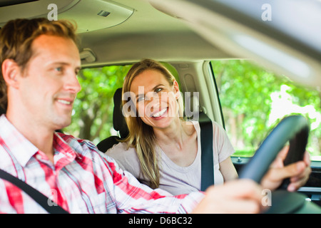 Smiling couple riding in car Stock Photo