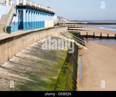 Sea wall and wooden groynes coastal defences on the beach at Walton on the Naze, Essex, England Stock Photo