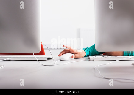Girl using computer at desk Stock Photo