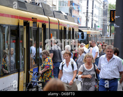 Passengers alight from a streetcar in downtown Karlsruhe, Germany, 28 August 2012. Ticket prices for busses and streetcars will increase again in south-west Germany. Rising gas prices and sinking numbers of pupils are responsible for the price increases. Photo: Uli Deck Stock Photo