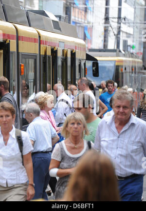 Passengers alight from a streetcar in downtown Karlsruhe, Germany, 28 August 2012. Ticket prices for busses and streetcars will increase again in south-west Germany. Rising gas prices and sinking numbers of pupils are responsible for the price increases. Photo: Uli Deck Stock Photo