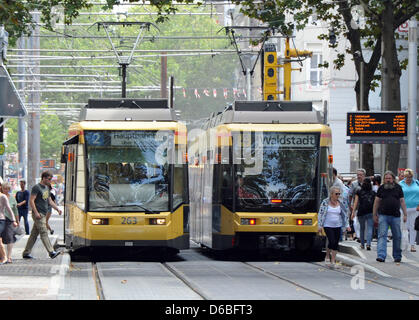 Two streetcars pass each other in downtown Karlsruhe, Germany, 28 August 2012. Ticket prices for busses and streetcars will increase again in south-west Germany. Rising gas prices and sinking numbers of pupils are responsible for the price increases. Photo: Uli Deck Stock Photo