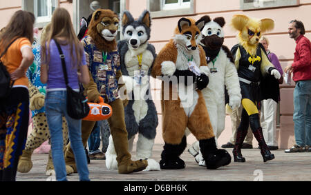 Visitors to the Eurofurence Convention talk in fanciul animal constumes through the inner city of Magdeburg, Germany, 31 August 2012. The 18th Eurofurence convention for furry fans is taking place in Magdeburg until 02 September 2012. Photo: JENS WOLF Stock Photo