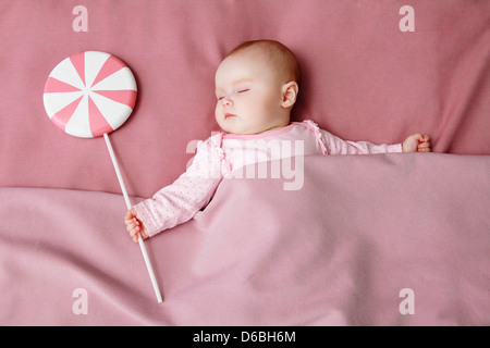 Baby girl sleeping in bed Stock Photo