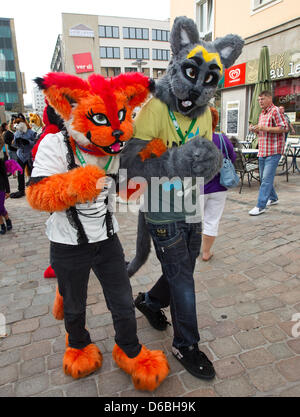 Visitors to the Eurofurence Convention talk in fanciul animal constumes through the inner city of Magdeburg, Germany, 31 August 2012. The 18th Eurofurence convention for furry fans is taking place in Magdeburg until 02 September 2012. Photo: JENS WOLF Stock Photo