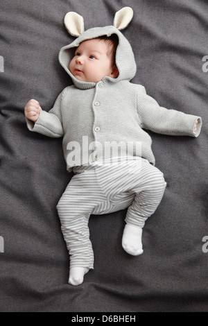 Baby boy laying on bed Stock Photo