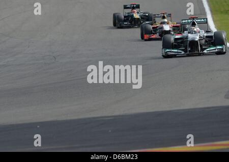 German Formula One driver Michael Schumacher of Mercedes AMG ahead of Spanish Pedro de la Rosa of HRT and Finnish Heikki Kovalainen of Caterham during the 2012 Belgium Formula One Grand Prix at the Spa-Francorchamps race track near Francorchamps, Belgium, 02 September 2012. Photo: David Ebener dpa Stock Photo