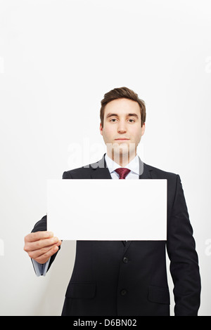Businessman holding blank card Stock Photo