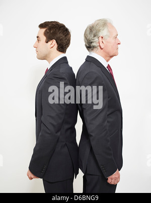 Two businessmen standing back to back Stock Photo - Alamy