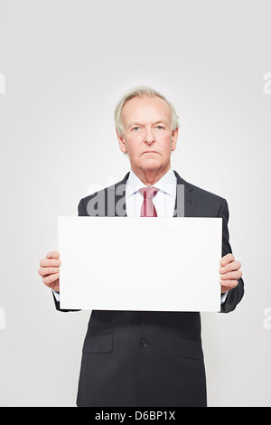 Businessman holding blank card Stock Photo