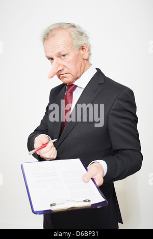Businessman with long nose and contract Stock Photo