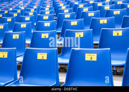 Seating rows in a stadium with weathered chairs Stock Photo