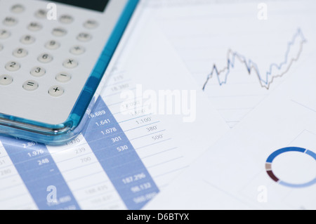 Business concept - Calculator and Charts, toned image. Stock Photo