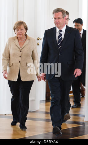 FILE - An archive picture dated 12 May 2011 shows German Chancellor Angela Merkel (CDU) walking next to German President Christian Wulff at Bellevue Palace in Berlin, Germany. After Wulff's televised interview SPD now sees the ball firmly in Merkel's court. Leading SPD politicians criticised new contradictions in Wulff's remarks on 05 January 2012. Photo: Tobias Kleinschmidt Stock Photo