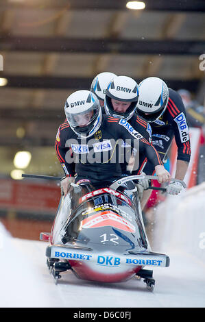 Bob pilot Maximilian Arndt and his pushers Alexander Roediger, Marko Huebenbecker and Martin Putze (Germany) start the second competition run of the four-man bob event at the bobsled World Cup in Altenberg, Germany, 08 January 2012. Again, the bob athletes finished in first place. Photo: ARNO BURGI Stock Photo