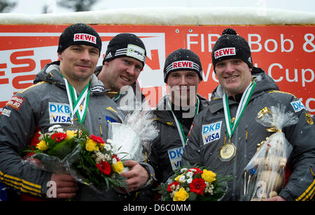 Bob pilot Maximilian Arndt (L) and his pushers Martin Putze , Marko Huebenbecker and Alexander Roediger (Germany) celebrate after the second competition run of the four-man bob event at the bobsled World Cup in Altenberg, Germany, 08 January 2012. Again, the bob athletes finished in first place. Photo: ARNO BURGI Stock Photo
