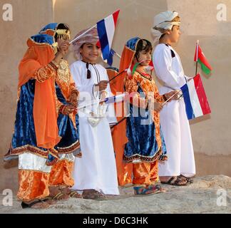 Children at Fort Nakhal wve with flags during the visit of Queen Beatrix, Prince Willem-Alexander and Princess Maxima (not in picture), 11 January 2012. The Dutch Royals are on a three-day State visit to Oman. Photo: Albert Nieboer / NETHERLANDS OUT Stock Photo