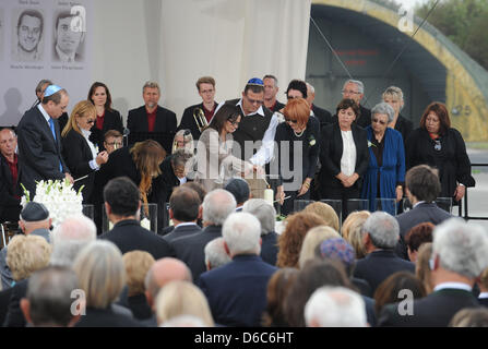 Relatives of the victims of the 1972 Munich Olympics massacre stand on stage after having lit up candles during the commemorative event for the victims of the Munich Olympic 1972 shootings at the air base in Fuerstenfeldbruck, Germany, 05 September 2012. On 05 September 1972, gunmen broke into the Israeli team's flat at the Olympic village, immediately killing two of the athletes a Stock Photo