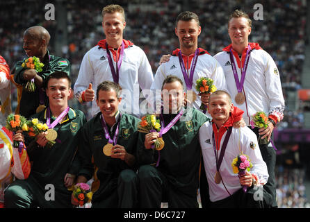 The German relay team Markus Rehm (l-r above), Heinrich Popow, David Behre and Wojtek Czyz are seen with their bronze medals and South Africans relay team and gold medalist Samkelo Radebe (l-r), Zivan Smit, Arnu Fourie and Oscar Pistorius during the victory ceremony for men's 4x100m relay -T42-46 at the Olympic Stadium during the London 2012 Paralympic Games, London, Great Britain, Stock Photo