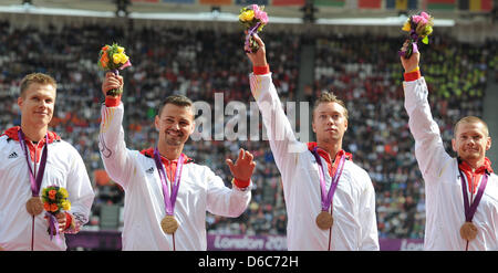 The German relay team Markus Rehm (l-r), Heinrich Popow, David Behre and Wojtek Czyz are seen with their bronze medals during the victory ceremony for men's 4x100m relay -T42-46 at the Olympic Stadium during the London 2012 Paralympic Games, London, Great Britain, 06 September 2012. Photo: Julian Stratenschulte dpa Stock Photo